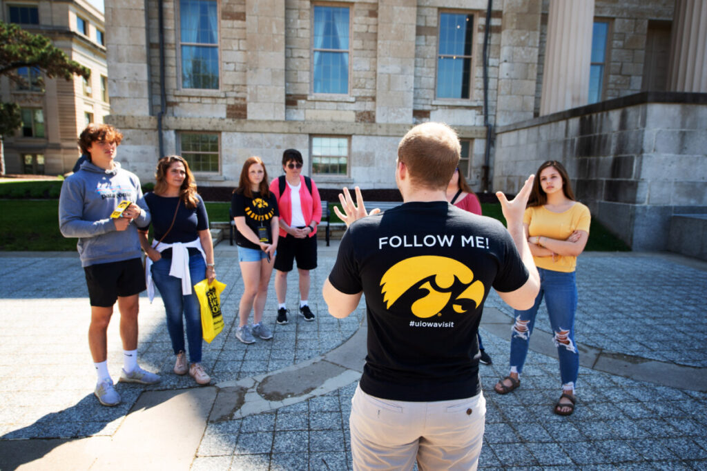 Student giving campus tour to tour group.