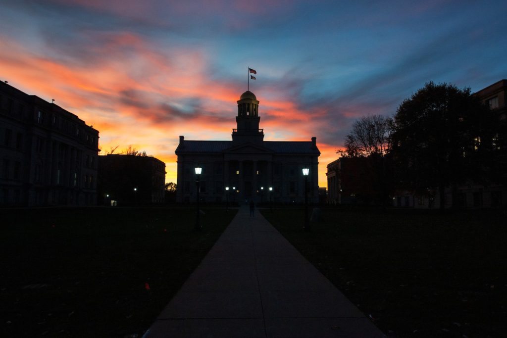 The Old Capitol building lit from behind from the sunset. Slightly eerie looking as the building silhouette is visable. 