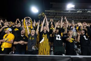 Hawkeye fans making an "I" with their hands at Kinnick.
