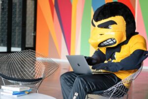 Herky typing on a laptop.