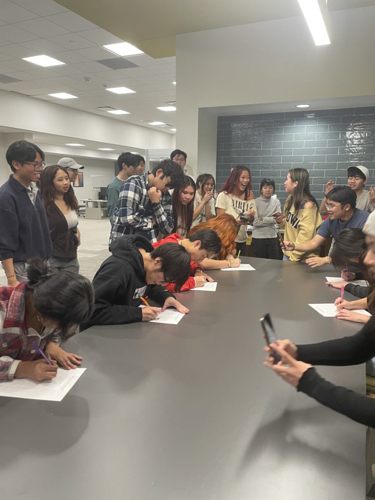 A photo of participants doing as many math problems as they could in a minute at the Minute to Win it GBM.