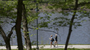 Two people walking by the Iowa river.