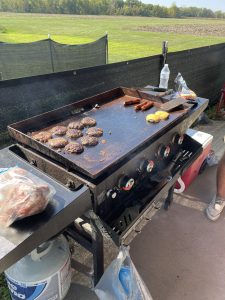 A picture of the food cooking at the grill out.